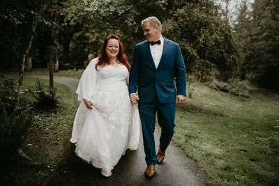 Bride and groom walking through a garden