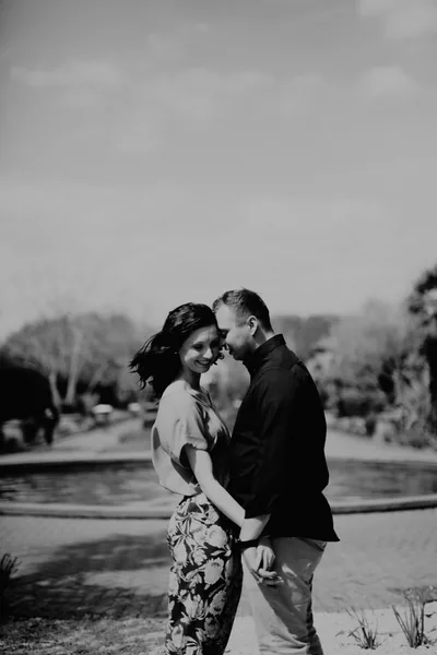 A couple embracing in a meadow, in black and white