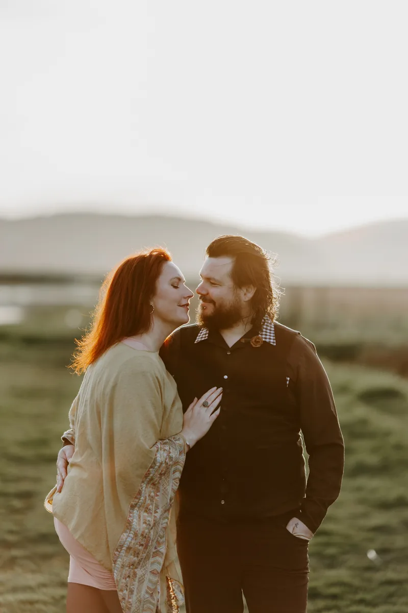 A couple laughing together beside the water