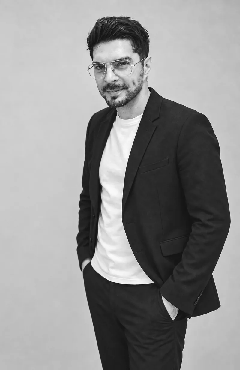 Black-and-white portrait of Alex Claudio